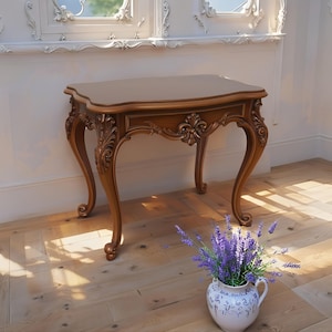 May include: A brown, antique-style side table with ornate carvings on the legs and apron. The table has a curved top and stands approximately 30 inches tall. A white and blue vase with lavender flowers sits on the floor in front of the table.