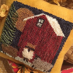 May include: A yellow pillow with a red barn, green trees, and a white sheep embroidered on it.