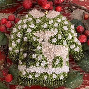 Può includere: Un ornamento natalizio verde e bianco a forma di maglione con un renna bianca e un disegno di albero di Natale bianco.