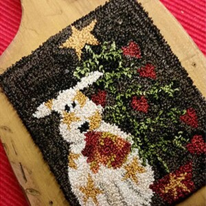 May include: A white, brown, and gold needlepoint rug with a stylized image of a dog standing in front of a green Christmas tree with red ornaments and a gold star on top.