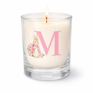 May include: A white ceramic mug with a black handle and the text "But First, Coffee" in a black, bold font. The mug is sitting on a wooden surface. The mug is approximately 4 inches tall.