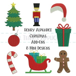 May include: A collection of eight Christmas-themed mini designs. Includes a green Christmas tree, a red and gold nutcracker, a Santa hat, a red ornament, a green gift box, a candy cane, a red sleigh with gifts, and a gingerbread man. Text reads "Henry Alphabet Christmas Add-Ons".