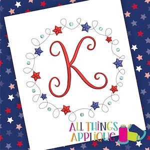 May include: Red and blue star embroidery design with a cursive letter K in the center. The design is surrounded by a black swirl pattern. The text "All Things Applique" is at the bottom of the image.