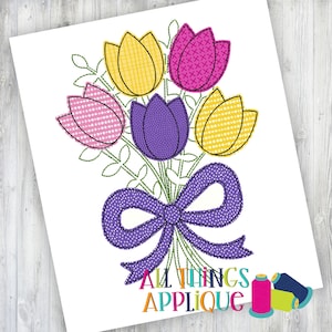 May include: Embroidered applique design of a bouquet of five tulips with a purple bow. The tulips are pink, yellow, purple, and white with different patterns. The design is perfect for embroidery projects.