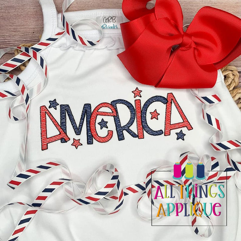 May include: White sleeveless shirt with a red, white, and blue "America" applique with stars. The shirt is decorated with red, white, and blue striped ribbon.