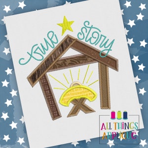 May include: A blue and yellow embroidery design of a manger with a star above it and the text "time story".
