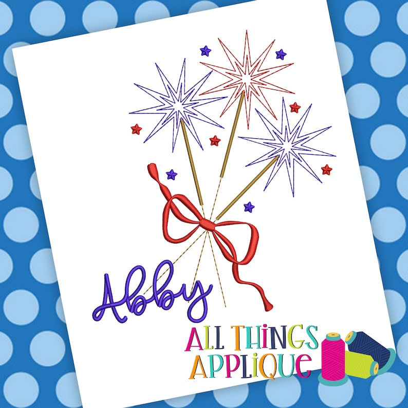 May include: Embroidered design of three sparklers tied together with a red bow. The name "Abby" is embroidered below the sparklers. The text "All Things Applique" is at the bottom of the design.