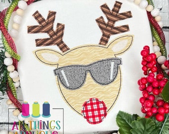 May include: Embroidered applique design of a reindeer wearing sunglasses and a red and white checkered nose. The reindeer is brown and white with a striped pattern on its antlers.