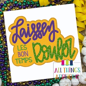 May include: A yellow, green, and purple embroidered applique design with the text "Laissez les bon temps rouler" in a white background.