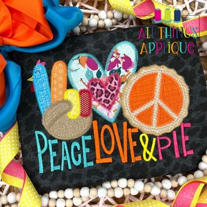 May include: Applique design featuring a turkey, heart, and peace sign with the text "Peace Love & Pie".