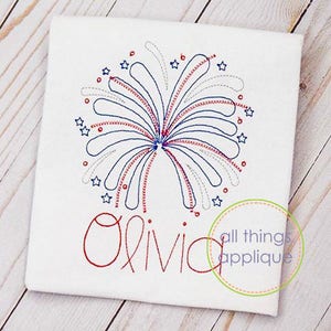 May include: An embroidered design of a red, white and blue firework with the name Olivia underneath. The design is on a white fabric background. The text "all things applique" is in a circle in the bottom right corner.