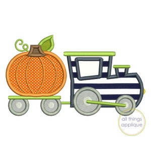 May include: An orange pumpkin with a green stem and brown stem detail is on a green train car with gray wheels. The train car is attached to a blue and white striped train engine with gray wheels. The train engine has a green roof and a black window.