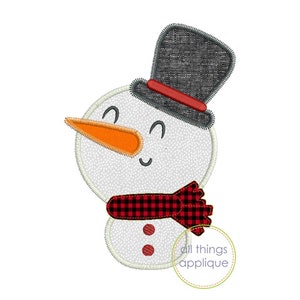 May include: A white snowman with a black top hat, red and black plaid scarf, and orange carrot nose. The snowman has two black eyes and a smiling mouth.