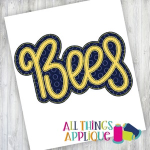 May include: A blue and yellow applique design of the word "Bees" in a cursive font. The design is on a white background.