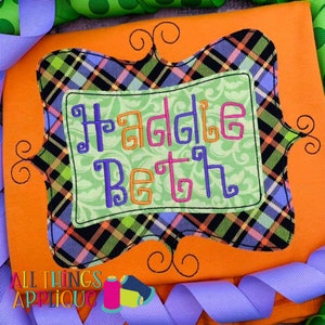 May include: A personalized embroidered design on an orange fabric with the name "Haddie Beth" in a decorative font. The design is framed with a black and green plaid border and a decorative scroll.