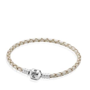 May include: A braided off-white leather bracelet featuring a cylindrical silver-toned metal clasp. The clasp is engraved with the letters PAN on its front surface. The bracelet has a circular shape and a smooth, woven texture throughout the leather band.