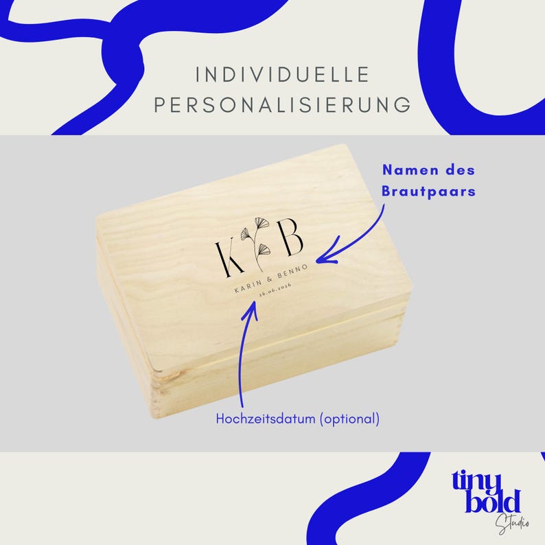 K&ouml;nnte beinhalten: Eine rechteckige Holzkiste in heller Farbe mit einem schwarzen Aufdruck, der die Buchstaben K und B zeigt, getrennt durch eine botanische Illustration. Darunter steht der Text KARIN & BENNO sowie ein Datum. Blaue Pfeile zeigen auf den Text.