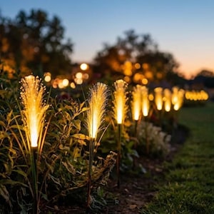 May include: A row of outdoor fiber optic garden lights shaped like tall grass stalks. Each light features a thin, vertical stem topped with a glowing, warm yellow spray of fiber optic filaments that mimic the appearance of illuminated wheat.
