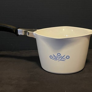 May include: White enamel saucepan with a black handle and a blue floral design.