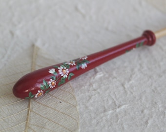 Painted Bayeux Lace Bobbin - a spiral of white daisies on a red background