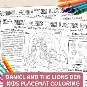 May include: A stack of two coloring placemats with the text "DANIEL AND THE LIONS DEN KIDS PLACEMAT COLORING". The placemats feature a Bible story scene with lions, angels, and people. Colored pencils and crayons are in the foreground.