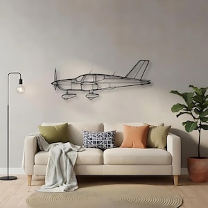 May include: A black metal wall art piece shaped like a single-engine airplane in profile. The design features a minimalist wireframe outline of the aircraft, including the propeller, cockpit windows, wings, landing gear, and tail section.