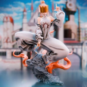 May include: A stylized anime-inspired figurine of a character wearing a gold crown over their eyes, a light gray sleeveless top with a dark red sun emblem, and matching loose pants. The figure stands on a dark gray rock with orange flame accents.