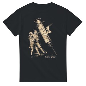 May include: A black short-sleeve t-shirt featuring a beige graphic print of a personified syringe with a face smoking a cigarette, standing next to a young couple. The text "Satan's Waitin'" is printed in a script font at the bottom of the graphic.