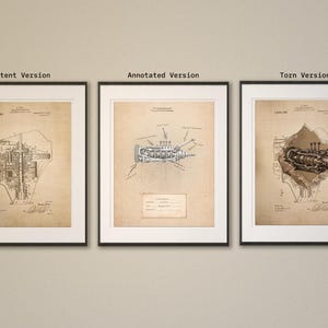 May include: Three framed vintage patent prints. The left print is labeled "Patent Version" and shows a detailed technical drawing. The center print, "Annotated Version", features a diagram with annotations. The right print, "Torn Version", shows a detailed mechanical drawing.