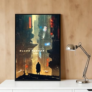 May include: A framed vertical poster featuring a dark, futuristic cityscape with towering buildings, glowing neon signs, and a silhouette of a person standing in the foreground. The text BLADE RUNNER is printed in white capital letters in the centre.