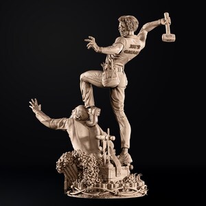 May include: A detailed sculpture depicting two figures in a dynamic pose. One figure stands atop the other, holding a hammer. The sculpture is in a neutral tone, with the text "JOE'S GARAGE" visible on the shirt of the standing figure.
