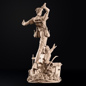 May include: A detailed sculpture of two figures, one standing atop the other. The top figure, wearing a work shirt with "JOE'S GARAGE" on the back, holds a tool aloft. The base features a teddy bear and barbed wire. The sculpture is a light brown color.