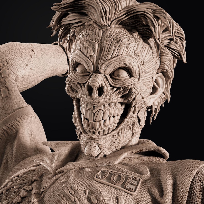 May include: A detailed sculpture of a zombie-like figure with exposed muscle and bone. The figure has a wide, toothy grin and stylized hair. The sculpture is in a neutral color and appears to be made of clay or a similar material. A patch on the figure's uniform reads "JOE".