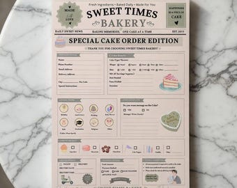 Peut inclure: Un bon de commande spécial de gâteau Sweet Times Bakery sur une table en marbre. Le formulaire est rose clair avec du texte et des illustrations noirs. Il comprend des sections pour les informations client, les détails du gâteau et les spécifications de la commande.