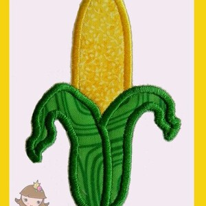 May include: Embroidered patch featuring a yellow corn cob with green husks. The corn has a detailed texture and is set against a white background with a yellow border. The patch is likely for clothing or accessories.