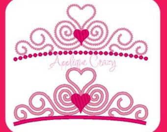 May include: Two pink and white princess crowns with heart details. The crowns are made of a swirl design with a heart in the center. The bottom crown has a row of pink beads.
