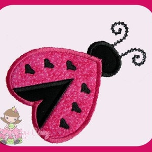 May include: Pink and black ladybug applique with a heart-shaped body and black antennae.