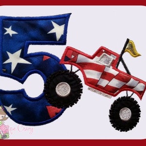 May include: A blue and red fabric applique of the number 5 with a red, white and blue monster truck on top. The number 5 has white stars on it. The monster truck has a yellow flag on top.