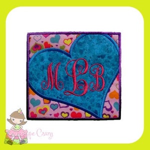 May include: A blue heart with a pink monogram "MLB" on a pink background with small hearts.