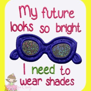 May include: Embroidered design with the text "My future looks so bright I need to wear shades" and a pair of purple sunglasses with sparkly lenses.