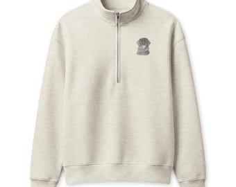May include: A light beige heathered quarter-zip sweatshirt featuring a small embroidered graphic of a dark gray dog on the upper left chest. The garment has a high collar, a silver-toned metal zipper, long sleeves, and ribbed cuffs and hem.