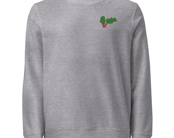 May include: A heather gray long-sleeve sweatshirt featuring a small embroidered design of green holly leaves and red berries positioned on the upper left chest area. The garment has a crew neckline and ribbed cuffs and hem.