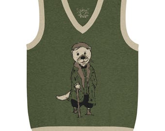 May include: An olive green V-neck sweater vest with beige trim at the neckline and hem. The front features a graphic illustration of an otter wearing a cap, a long coat, and dark trousers, while leaning on a wooden walking stick. The fabric has a knit texture.