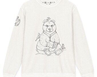 May include: A white long-sleeve crewneck sweatshirt featuring a black line drawing of a bear wearing glasses and a quilted jacket, reading a book titled How to Spot a Bird. Small birds are perched on the bear's head and shoulders.