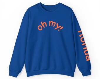 May include: A royal blue long-sleeve sweatshirt featuring the orange text "oh my!" printed in a curved arc across the chest. The left sleeve displays the orange text "nomad" printed vertically in a bold, sans-serif font style.