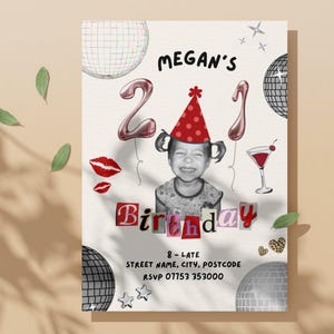 21st Birthday Invitation Template featuring a picture of a toddler wearing a party hat, balloons with a 2 and a 1, disco balls, scrapbook lettering, a cocktail, disco balls, lipstick kisses, sparkles, leopard print hearts and black text with the event details. The invite is on a beige wall with the shadow of a tree and leaves across the image.