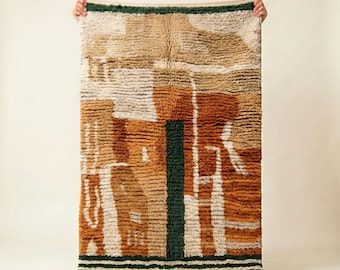 May include: A rectangular, textured rug with a geometric design. The rug features a color palette of beige, brown, and white, with a vertical green stripe. The rug is held up by two hands.