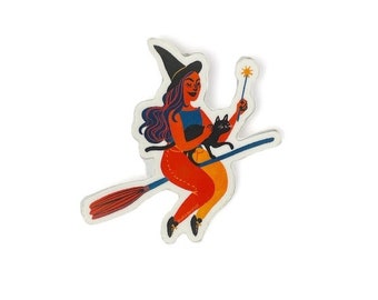 May include: A sticker of a witch flying on a broomstick with a black cat in her arms. She is wearing a black hat and a red and orange dress. She is holding a wand in her right hand.