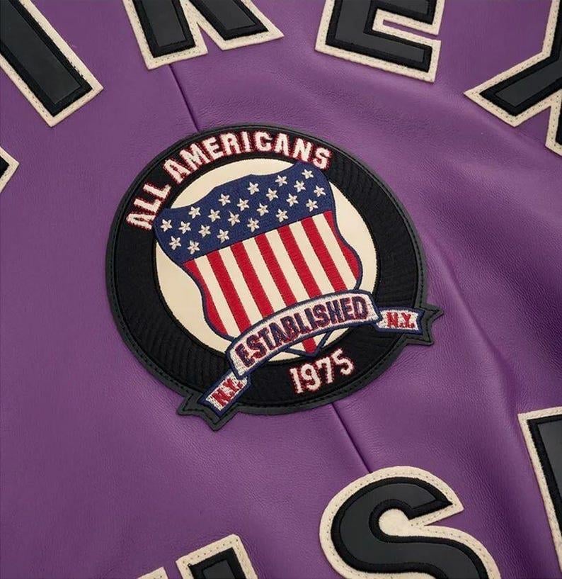 May include: A white ceramic mug with a black handle and the text "But First, Coffee" in a bold, black font. The mug is set against a blurred background, suggesting a cozy setting. The mug appears to be approximately 4 inches tall.