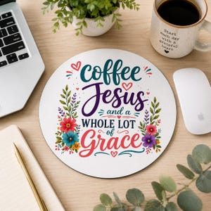 May include: A round white mousepad featuring the text "coffee Jesus and a WHOLE LOT of Grace" in teal, purple, and red script and block lettering, surrounded by colorful floral illustrations of red, blue, yellow, and purple flowers and green leaves.